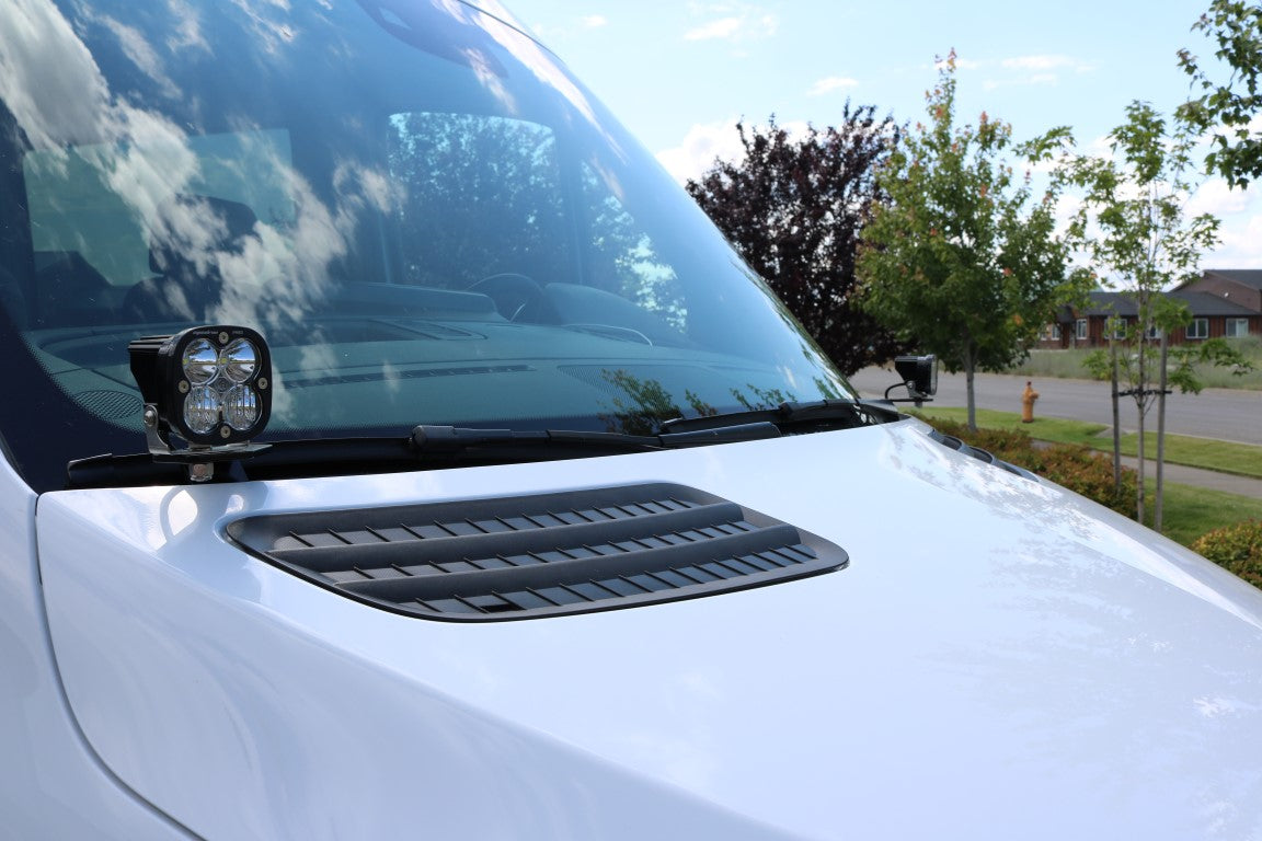 Close-up of HOODLINE LIGHT POD MOUNT - SPRINTER (2019+) by VAN COMPASS, showcasing bolt-on mounts attached to a car hood.