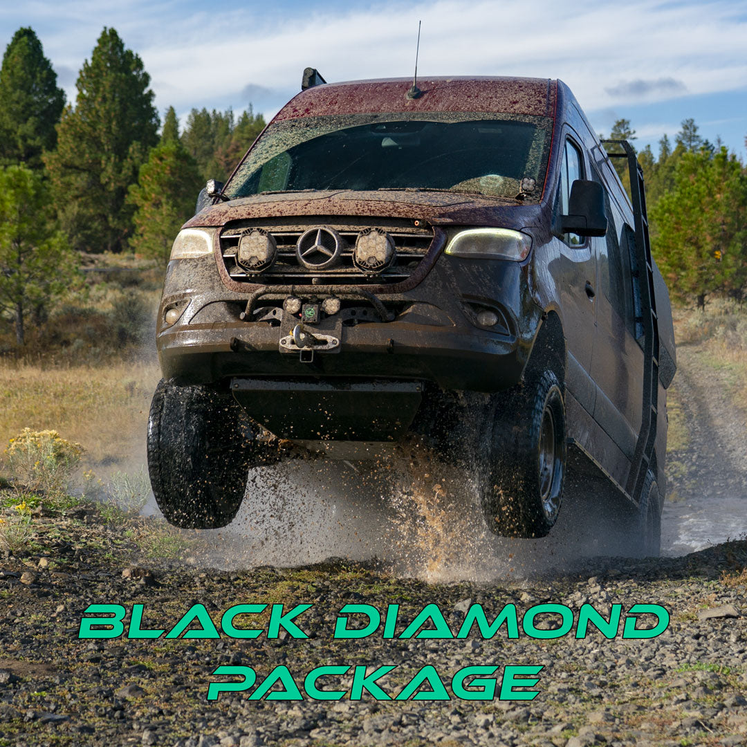 A vehicle driving through a muddy field, showcasing its rugged tires and off-road capabilities.