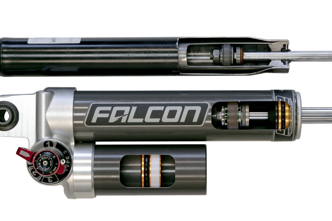 Close-up of the Stage 2.3 System by Van Compass, featuring adjustable Falcon 3.3 shocks with Fast Adjust knobs for improved van handling and stability.