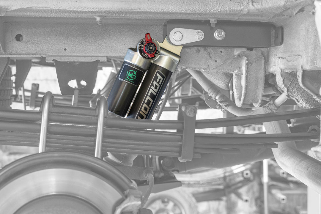 Two black and silver air compressors under a vehicle, part of the STAGE 2 SYSTEM - SPRINTER 2WD (2007+ 2500 ONLY) by VAN COMPASS, enhancing van suspension and stability.