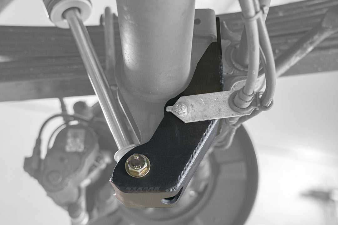 BAJA SUR Heavy Duty Rear Lower Shock Brackets for Sprinter 2500, showcasing close-up of sturdy metal construction designed to reinforce lower shock mounts.