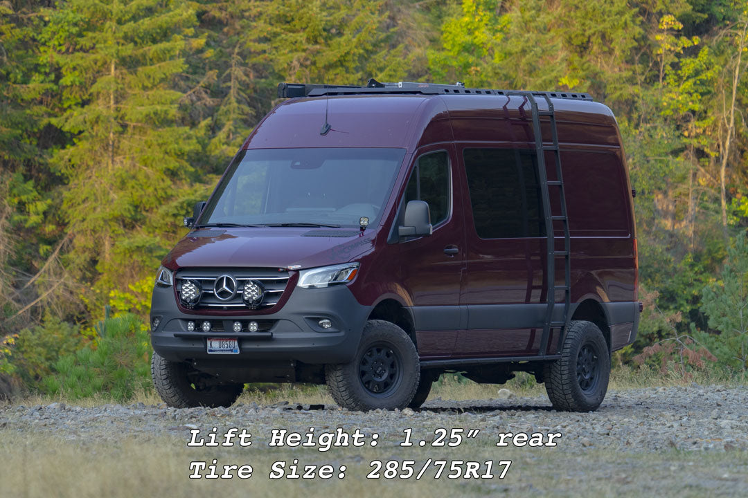 Red van on gravel, showcasing Van Compass STAGE 4.3 SYSTEM - SPRINTER AWD, 4x4 (2015-Present 2500), highlighting adjustable Falcon 3.3 shocks and enhanced suspension benefits.