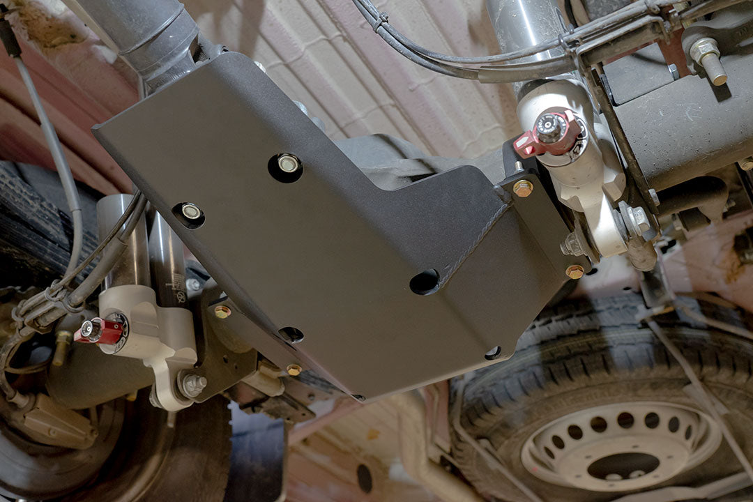 Differential skid plate for Sprinter 2015+ 3500 by Van Compass, shown installed under a vehicle, protecting the rear differential and driveshaft u-joints.