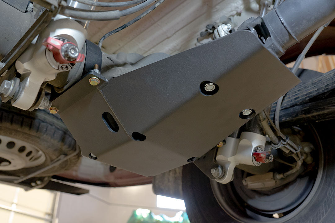 Differential Skid Plate - Sprinter (2015+ 3500 Only) by Van Compass shown attached under a vehicle, offering protection to the rear differential and driveshaft u-joints.