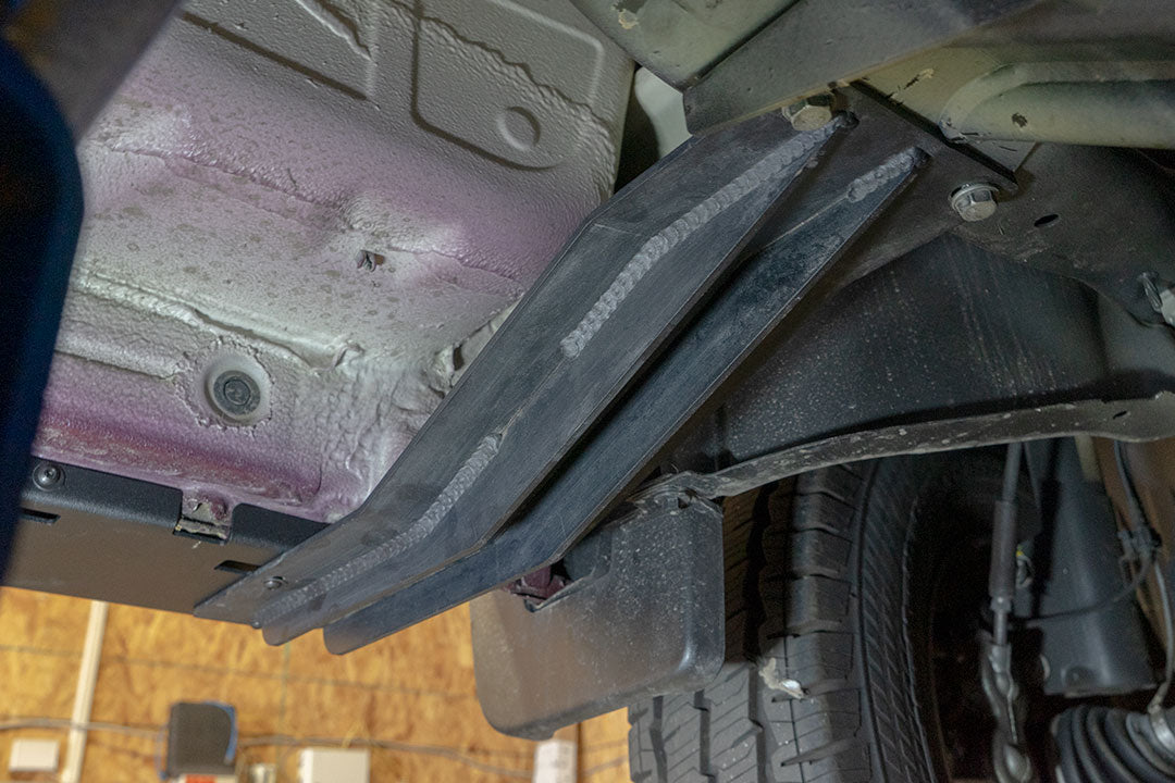 Close-up of Van Compass Rocker Guards for Sprinter 4x4, highlighting the sturdy metal frame and integrated step surface for ease of access and vehicle protection.