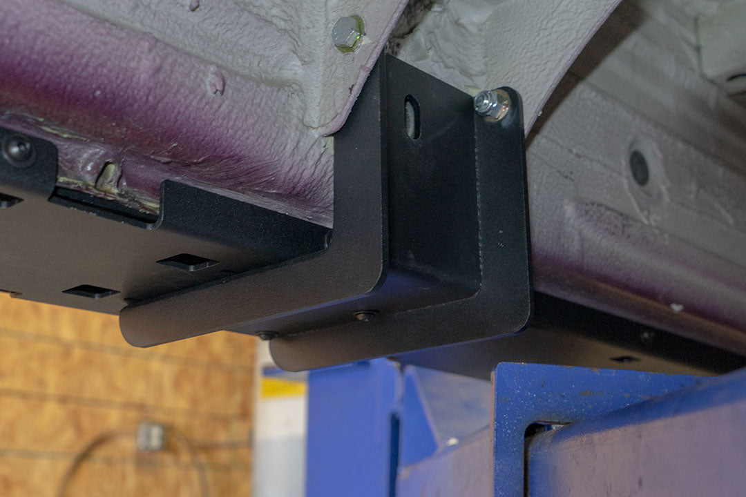 Rocker Guards for Sprinter 4x4, showcasing a close-up of the sturdy metal brackets and bolts, enhancing chassis rigidity and vehicle protection.