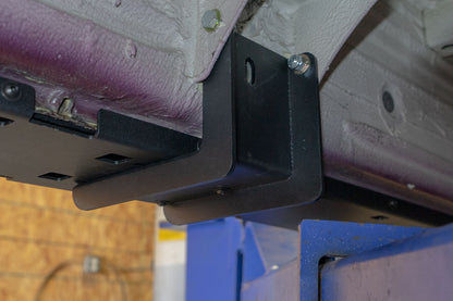 Rocker Guards for Sprinter 4x4, showcasing a close-up of the sturdy metal brackets and bolts, enhancing chassis rigidity and vehicle protection.