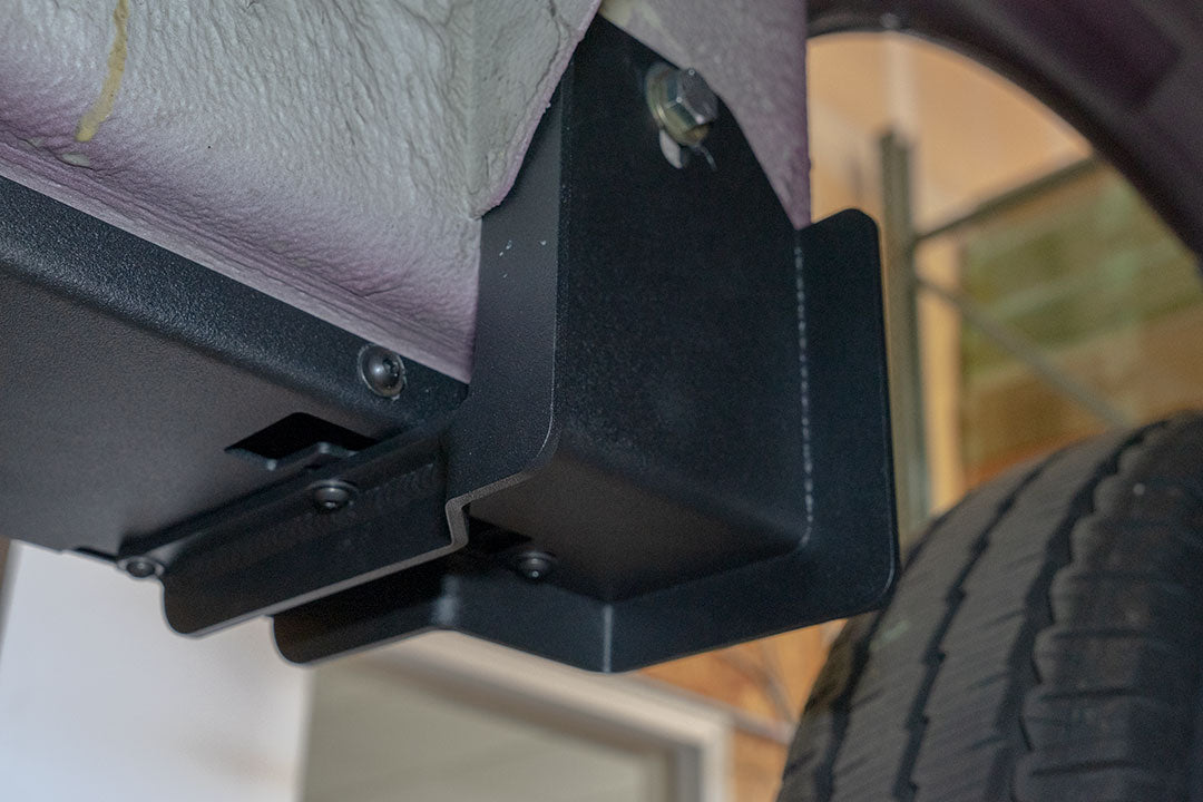 Rocker Guards for Sprinter 4x4, featuring black metal brackets and steps, providing chassis protection and ease of access.