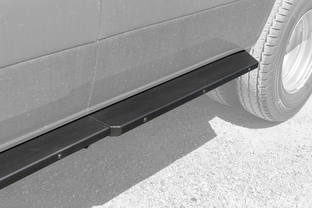 Rocker Guards - Sprinter 4x4 (2015-2022 170 Wheelbase Only) by Van Compass: Close-up of sturdy vehicle step and tire, showcasing robust steel construction for enhanced access and protection.