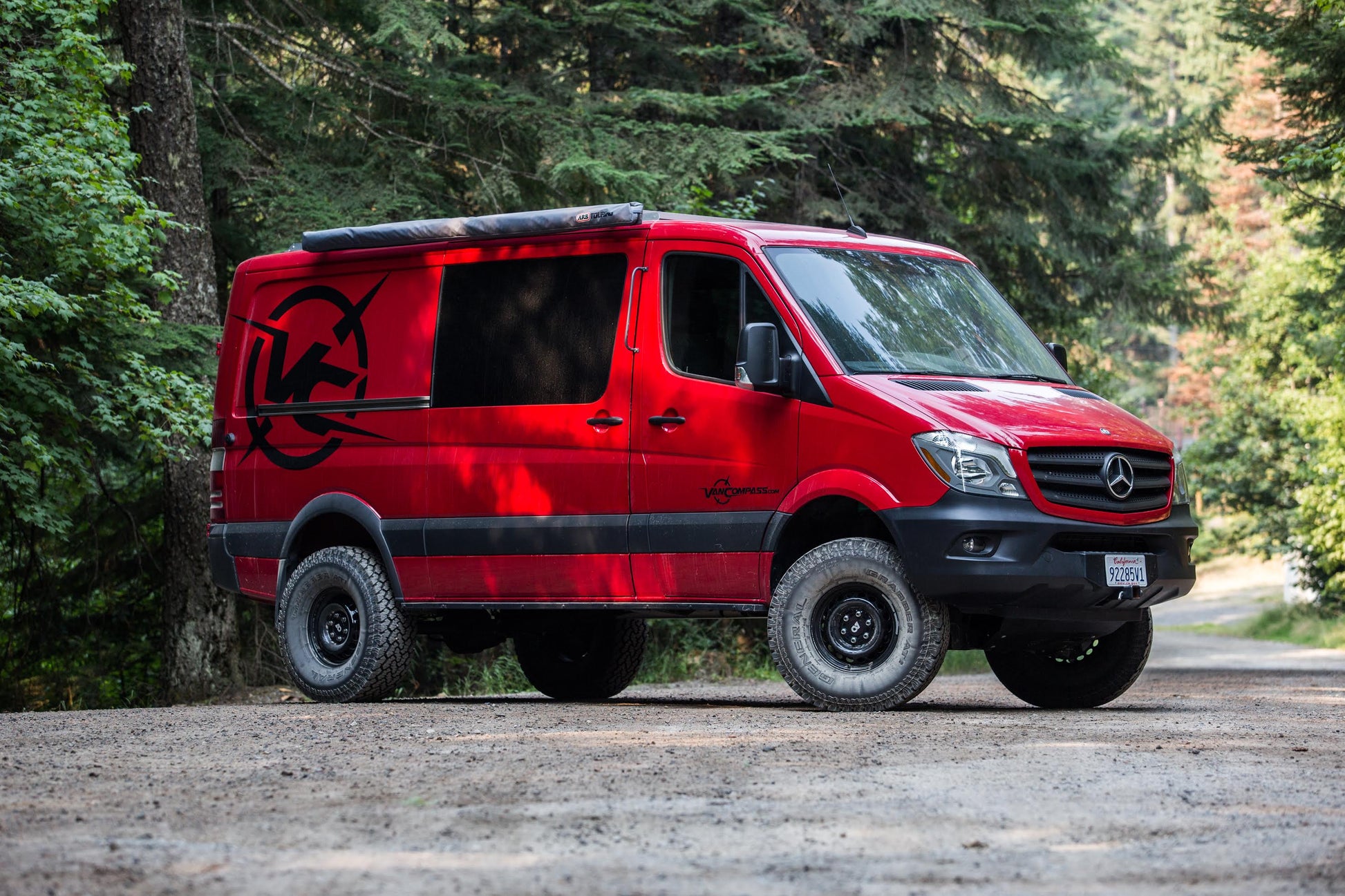 Red van on gravel road showcasing STRIKER 4X4 2 Lift Kit for Sprinter 4x4 (2015-2022 2500 SRW), highlighting enhanced tire clearance and off-road capability.