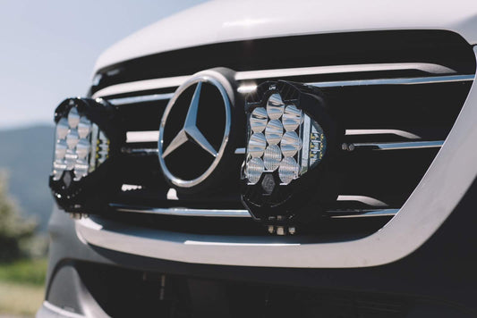 Close-up of the Van Compass Floating Light Mount installed on a 2019-present Sprinter, showcasing its aggressive styling and precise fit behind the grille.