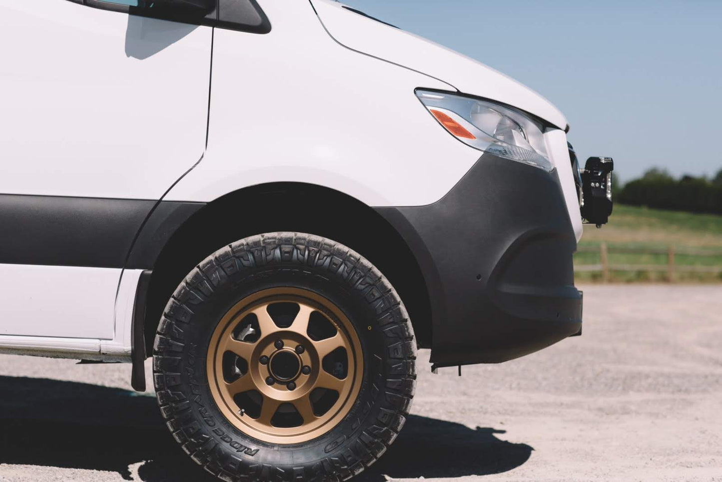 STRIKER 2 Lift Kit for Sprinter 2WD (2019-2022 2500 and 3500) by VAN COMPASS, shown installed on the front of a white van, highlighting increased ground clearance.