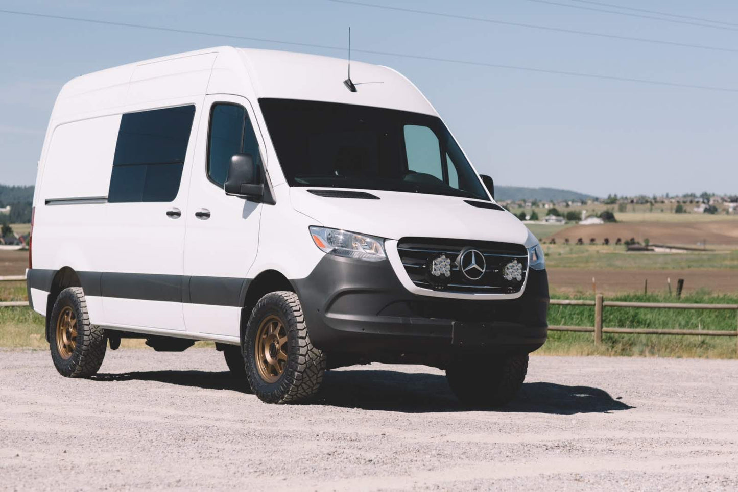 Striker 2 Lift Kit by Van Compass for 2019-2022 Sprinter 2WD, shown on a white van for increased off-road clearance and tire compatibility.