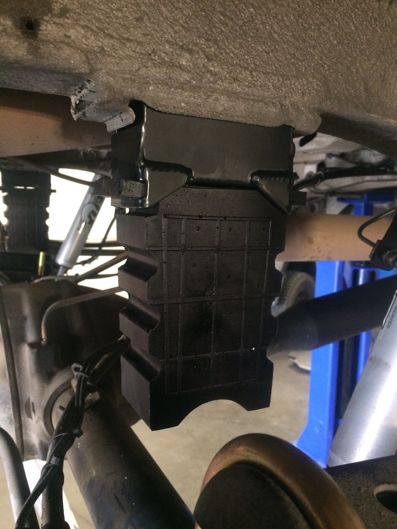 SUMO SPRING REAR BUMP STOPS - SPRINTER (1994+ 2500 ONLY) PAIR installed under a vehicle, enhancing rear suspension performance and stability for heavy loads or towing.