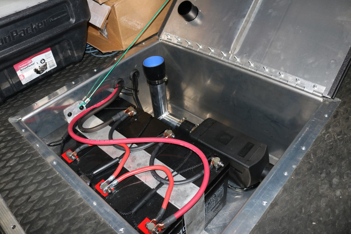 Rear Storage Trunk - Sprinter (2007+) by Van Compass, a sealed aluminum trunk with wires and cables, designed for auxiliary battery housing and other functionalities.