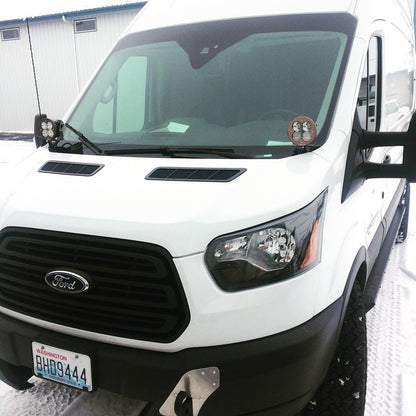 HOODLINE LIGHT POD MOUNT - TRANSIT (2013+) by VAN COMPASS. Close-up of a white van's front, highlighting the headlight area where the mounts install.