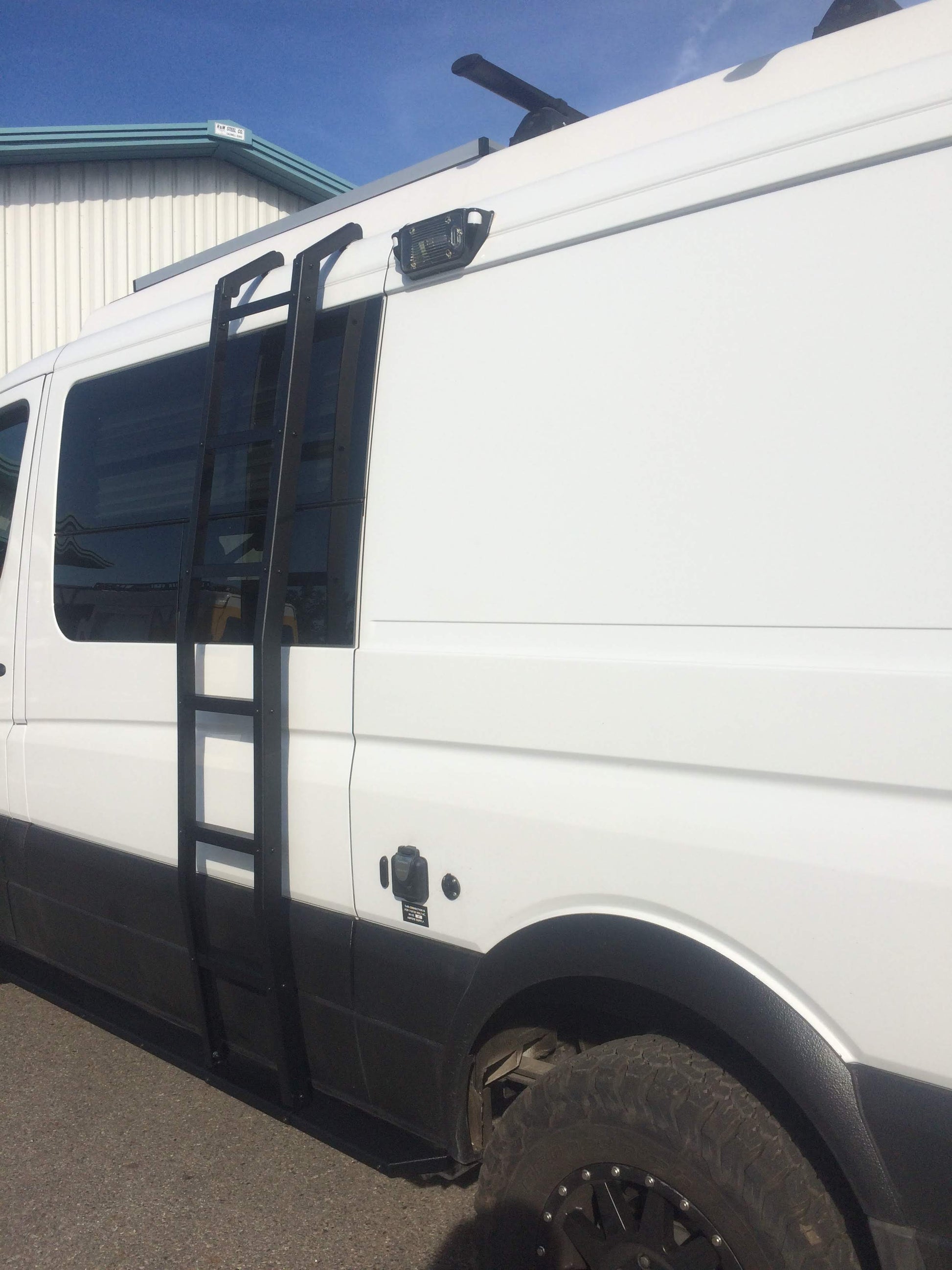 White van with a side ladder installed for easy roof access, compatible with 2007-current low roof Sprinter models by Van Compass.